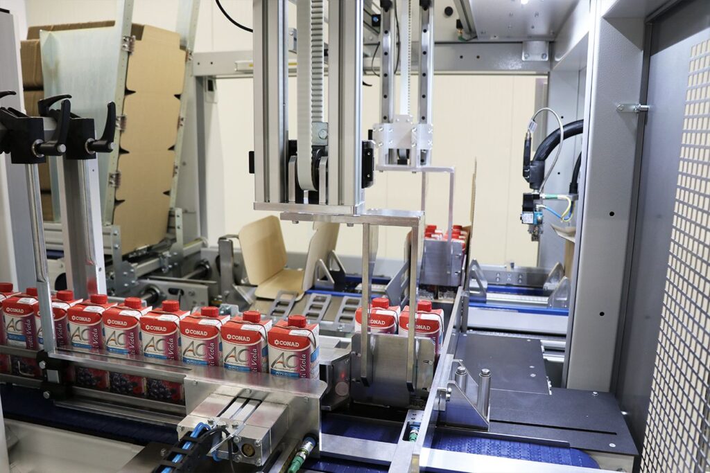 Máquina Embalaje donde se pueden apreciar las diferentes leches que hay que están siendo embaladas y empaquetadas